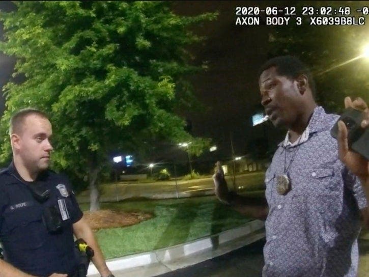 This image taken from body camera video provided by the Atlanta Police Department shows Rayshard Brooks speaking with former Officer Garrett Rolfe in the parking lot of a Wendy's restaurant, late Friday, June 12, in Atlanta. Rolfe shot Brooks as he fled.
