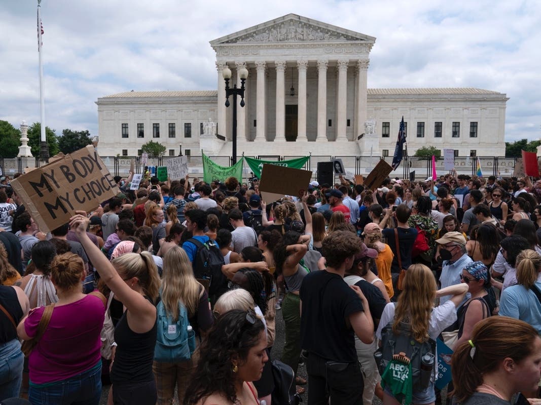 Demonstrators gather outside the Supreme Court in Washington Friday to protest the ruling. 
