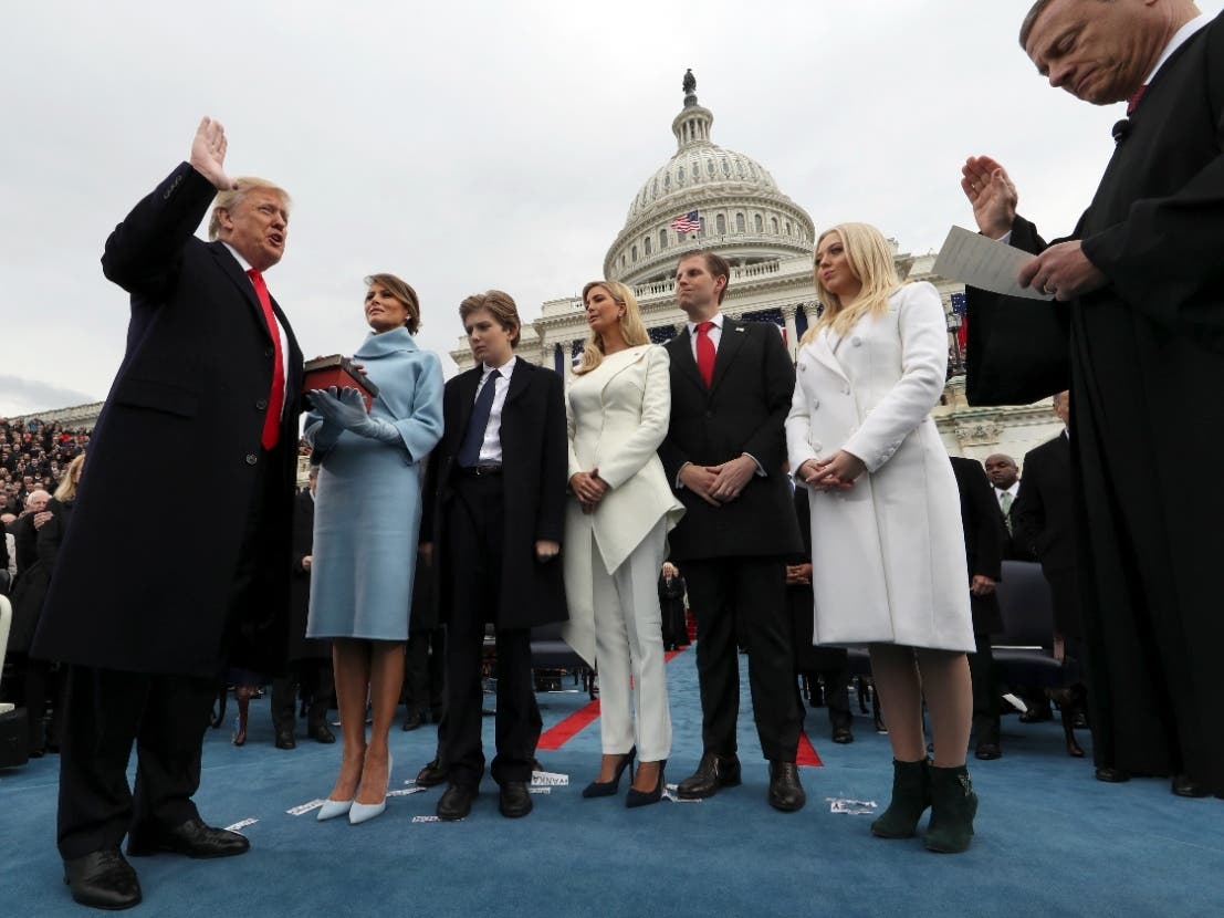 In this Jan. 27, 2017, file photo President Donald Trump takes the oath of office from Chief Justice John Roberts, as his wife Melania holds the Bible, and with his children Barron, Ivanka, Eric and Tiffany on Capitol Hill in Washington. 