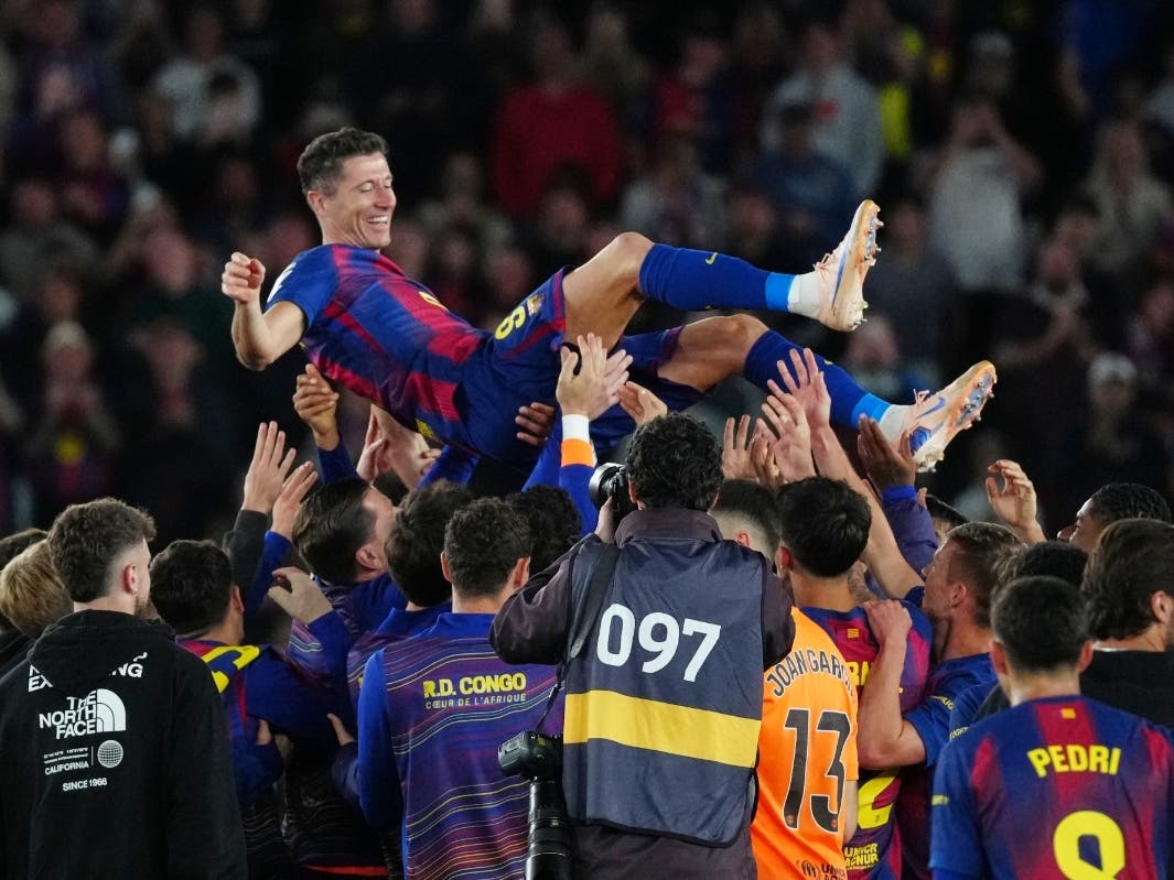 Barcelona's Robert Lewandowski is thrown into the air by his teammates after his last game for the club at the end of the Spanish La Liga soccer match between FC Barcelona and Real Betis on May 17 in Barcelona, Spain.