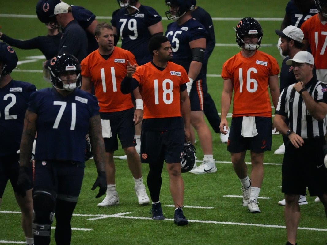 Chicago Bears quarterback Caleb Williams (18) leads the players at NFL football training camp earlier this month in Lake Forest.