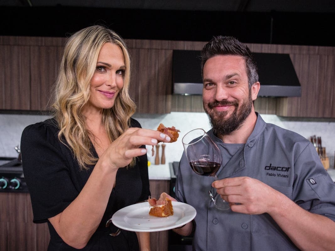 Actress and model Molly Sims and Chef Fabio Viviani cook up fine Italian cuisine in this 2017 photo in Pebble Beach, California. (Photo by Tomas Ovalle/Invision for Dacor/