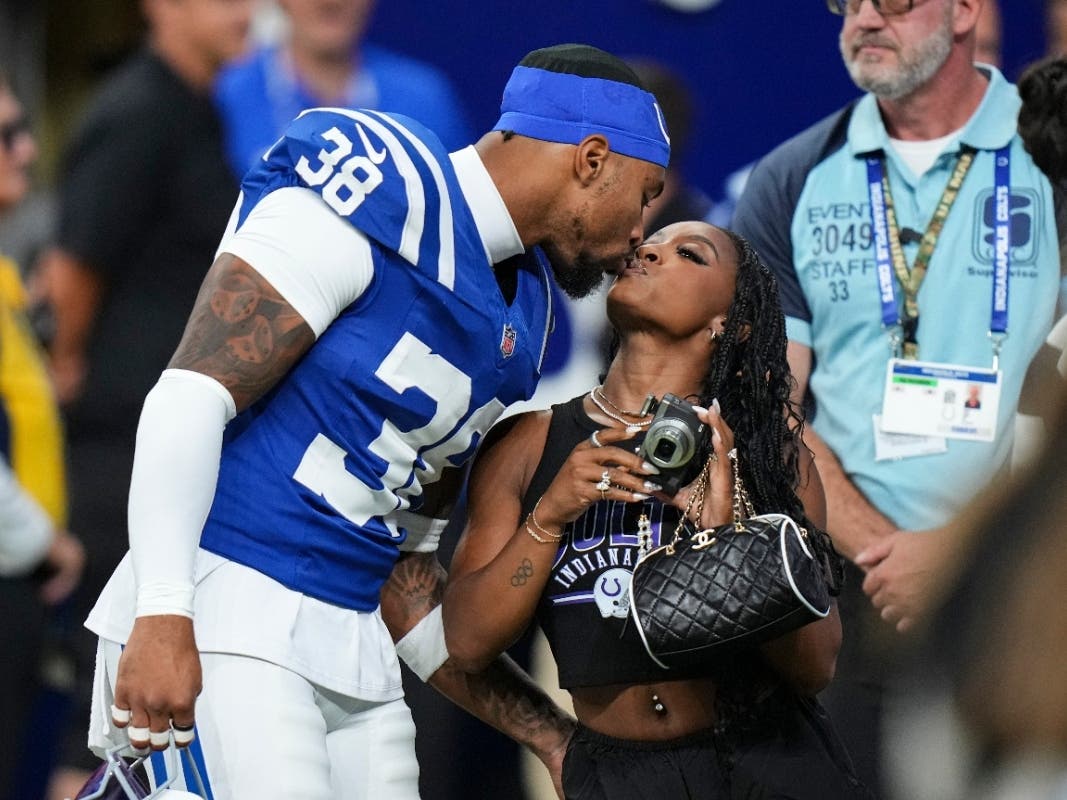 Indianapolis Colts safety Jonathan Owens (38) kisses his wife, gymnast Simone Biles, before the start an NFL football game last month against the Atlanta Falcons in Indianapolis.