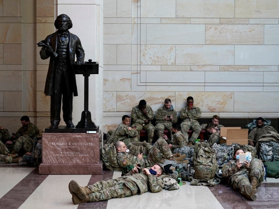 Troops hold inside the Capitol Visitor's Center to reinforce security at the Capitol in Washington, Wednesday, Jan. 13, 2021.