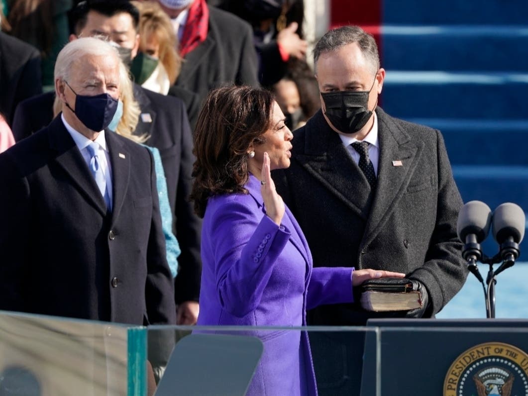 Kamala Harris is sworn in as vice president by Supreme Court Justice Sonia Sotomayor as her husband Doug Emhoff holds the Bible during the 59th Presidential Inauguration at the U.S. Capitol in Washington, Wednesday, Jan. 20, 2021.