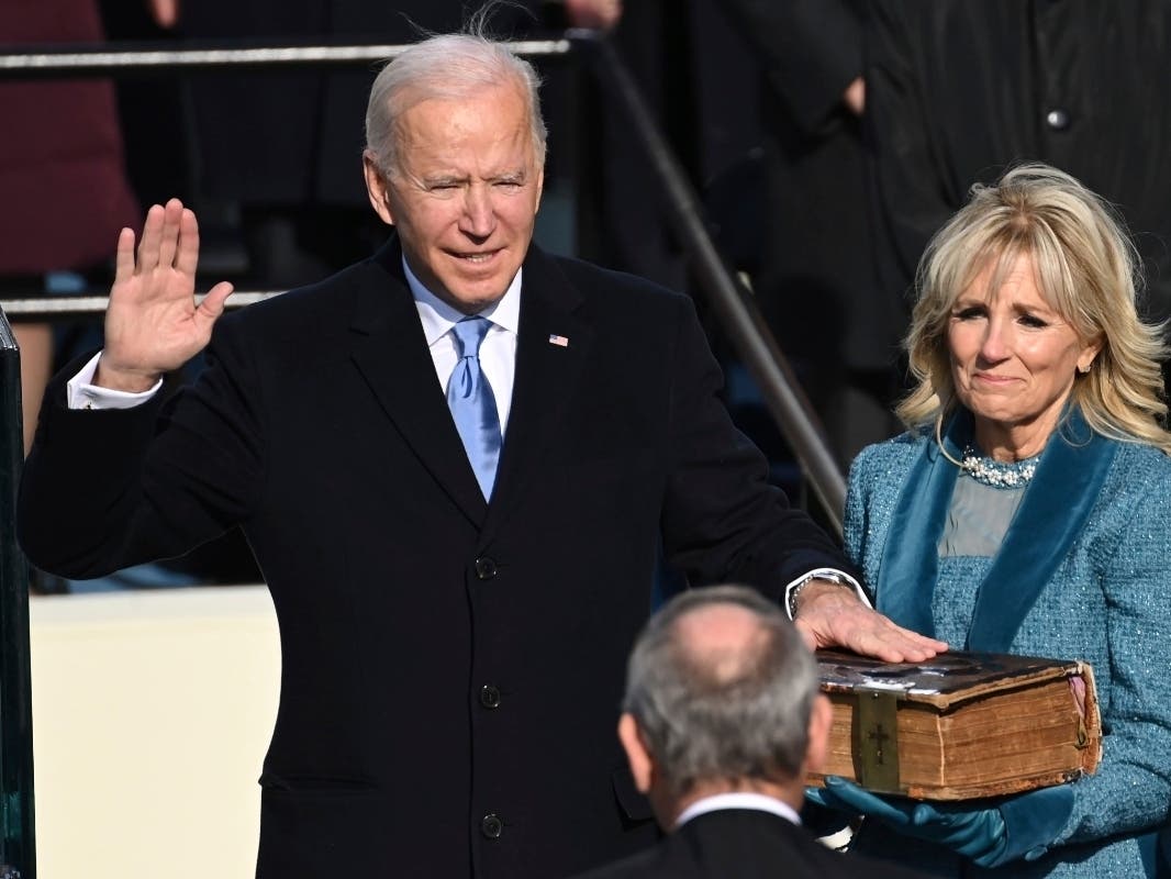 Joe Biden is sworn in as the 46th president of the United States by Chief Justice John Roberts as Jill Biden holds the Bible during the 59th Presidential Inauguration at the U.S. Capitol in Washington, Wednesday, Jan. 20, 2021.
