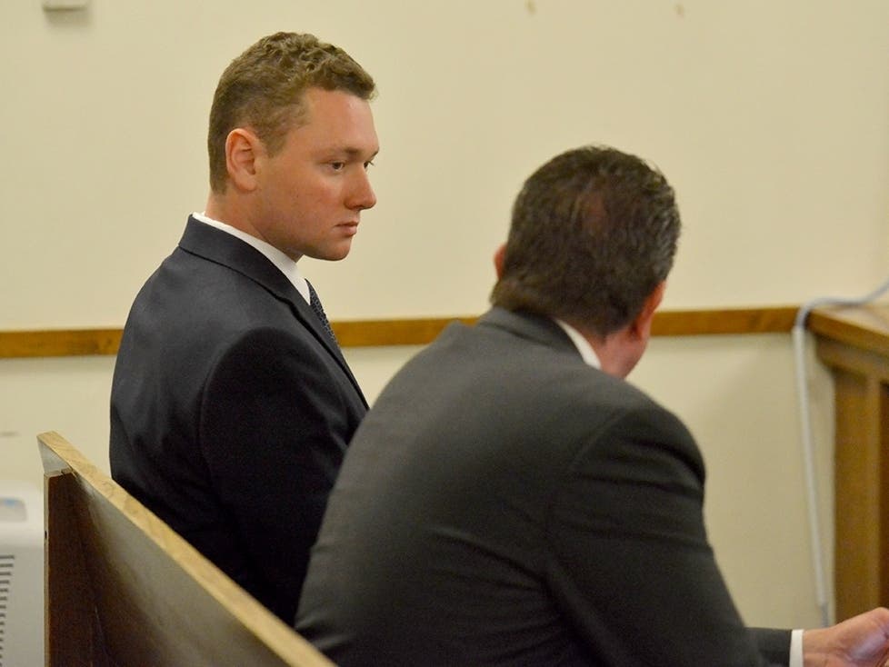 Reid Mason, left, talks with his attorney Peter Lloyd in the third session courtroom of Barnstable District Court as they wait for Mason's hearing to begin, Tuesday, May 24, 2022, in Barnstable, Mass.