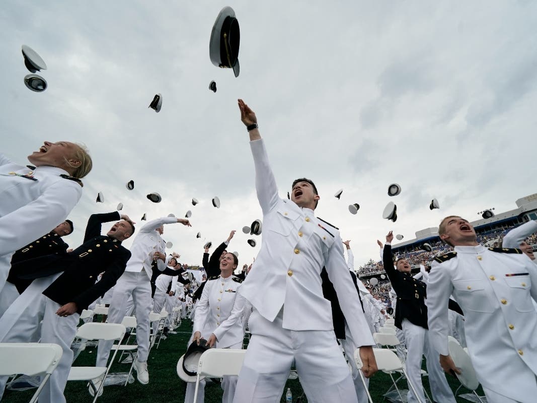 President Joe Biden will address the Class of 2022 at the United States Naval Academy's graduation ceremony on May 27 in Annapolis. The photo above shows midshipmen tossing their caps after last year's ceremony at Navy-Marine Corps Memorial Stadium.