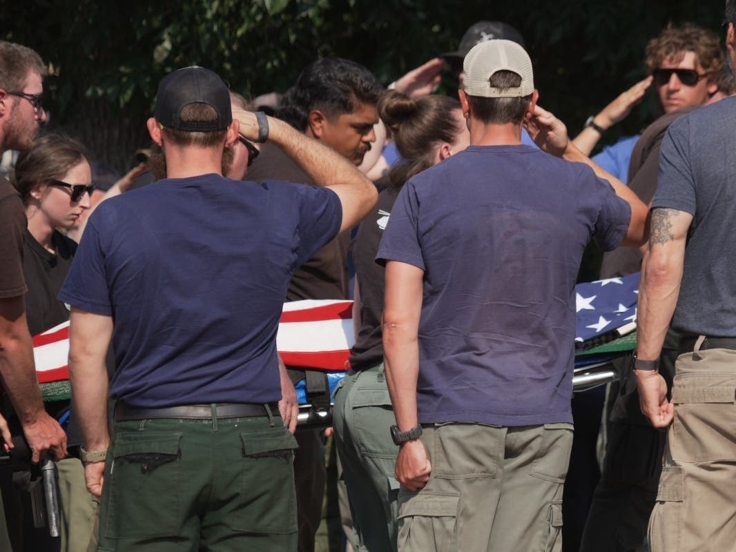 The body of a firefighter who died battling wildfires near the Colorado-Utah border is carried during a procession in Grand Junction, Colo., Monday, June 29, 2026.