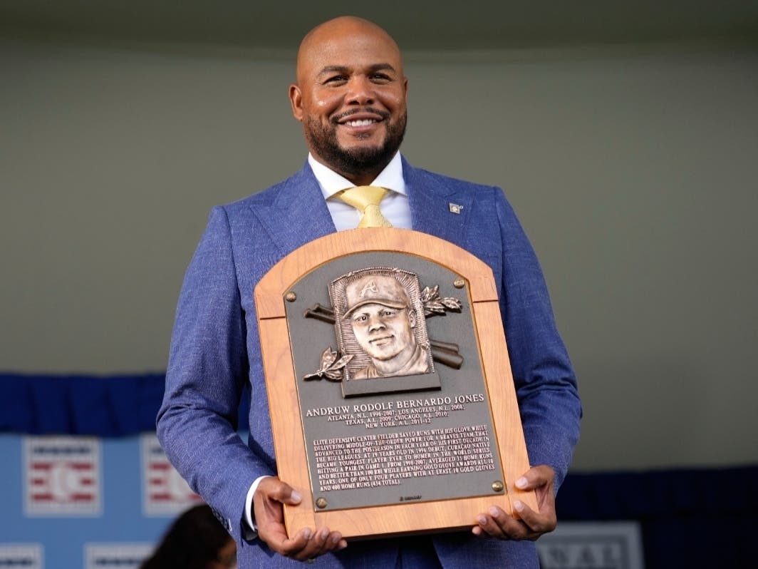 Andruw Jones holds up his Baseball Hall of Fame plaque after the induction ceremony in Cooperstown, N.Y., Sunday, July 26, 2026.