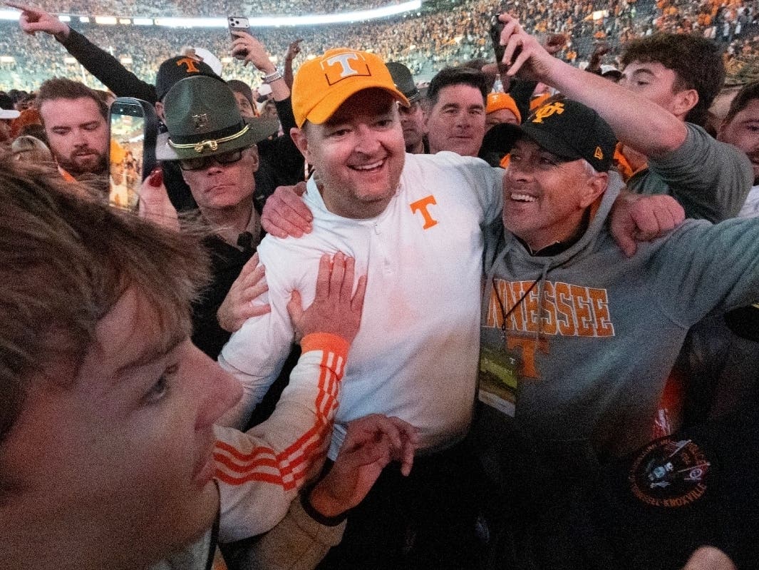 Tennessee head coach Josh Heupel, center, celebrates with fans after an NCAA college football game against Alabama, Saturday, Oct. 17, 2026, in Knoxville, Tenn.