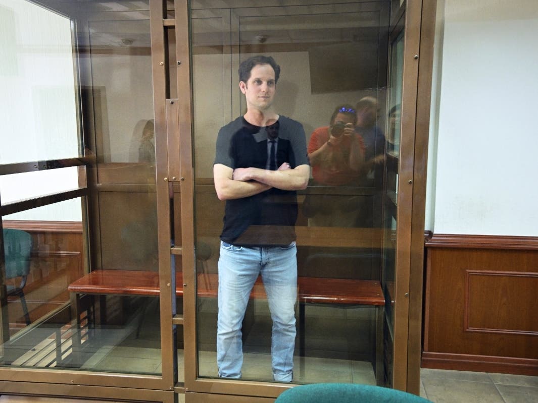 Wall Street Journal reporter Evan Gershkovich stands in a glass cage in a courtroom at the Moscow City Court in Moscow, Russia, Thursday, June 22, 2023. 