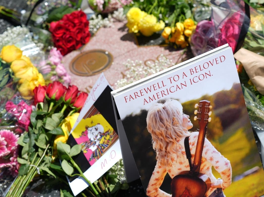 Dolly Parton built a better world, with rhinestones and songs Dolly Parton's star on the Hollywood Walk of Fame is decorated with flowers Tuesday, Aug. 25, 2026, in Los Angeles.