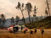 Howard Forest Helitack firefighters return to their helicopter after battling the LNU Lightning Complex on Sunday in unincorporated Lake County, Calif. 