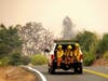 Firefighters ride in the back of a pickup truck while battling the LNU Lightning Complex fires Sunday, Aug. 23, 2020, in unincorporated Lake County, Cailf. 