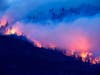 The Creek Fire burns Monday along a hillside in the Cascadel Woods community of Madera County, Calif.
