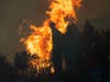 Firefighters monitor a controlled burn along Nacimiento-Fergusson Road to help contain the Dolan Fire near Big Sur, Calif., Friday, Sept. 11, 2020. 