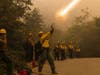 A firefighter shoots an incendiary device during a back burn to help control the Dolan Fire at Limekiln State Park in Big Sur, Calif,. Friday, Sept. 11, 2020. 