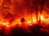 A firefighter battles the Creek Fire as it threatens homes in the Cascadel Woods neighborhood of Madera County, Calif., on Sept. 7. 