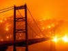 In this image taken with a slow shutter speed, embers light up a hillside behind the Bidwell Bar Bridge as the Bear Fire burns in Oroville, Calif., on Wednesday. 