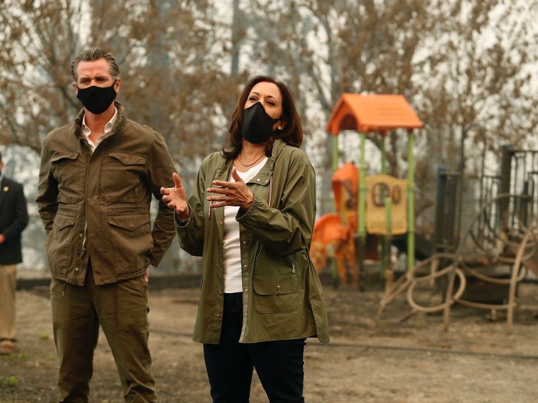 California Gov. Gavin Newsom listens as Democratic vice presidential candidate Sen. Kamala Harris, D-Calif., talks as they asses the damage during the Creek Fire at Pine Ridge Elementary, Tuesday, Sept. 15, 2020, in Auberry, Calif. 