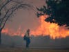 Capt. Dan Engkraf of Los Angeles County Fire stands walks along the driveway of a home along Cima Mesa Rd. as crews protect structures from the advancing Bobcat fire Friday, Sept. 18, 2020, in Juniper Hills, Calif. 