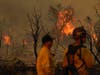 Members of the San Bernardino County Fire Department keep an eye on a flare-up from the Bobcat Fire on Saturday in Valyermo, Calif. 