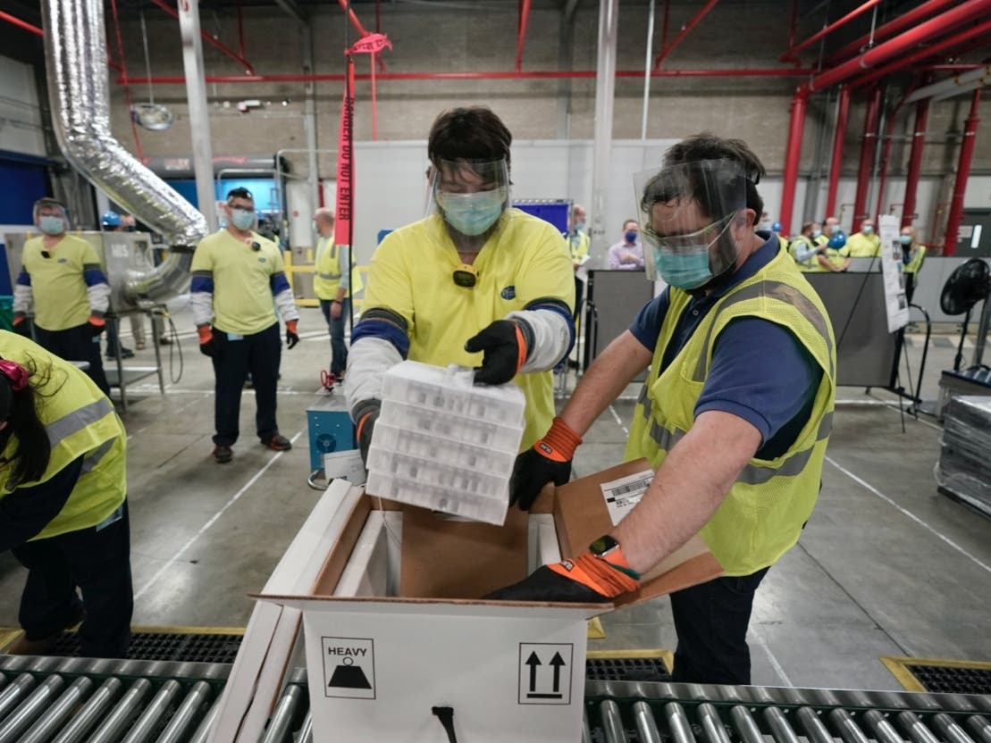 Boxes containing the Pfizer-BioNTech COVID-19 vaccine are prepared to be shipped at the Pfizer Global Supply Kalamazoo manufacturing plant in Portage, Mich., Sunday, Dec. 13, 2020. 