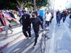 A counterdemonstrator (center) is chased by Trump supporters Wednesday outside of City Hall in Los Angeles. Demonstrators supporting President Donald Trump are gathering in various parts of Southern California. 