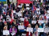 Protesters hold signs Wednesday outside of City Hall in Los Angeles. Demonstrators supporting President Donald Trump are gathering in various parts of Southern California.
