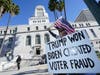 A protester holds a sign Wednesday outside of City Hall in Los Angeles. Demonstrators supporting President Donald Trump are gathering in various parts of Southern California.