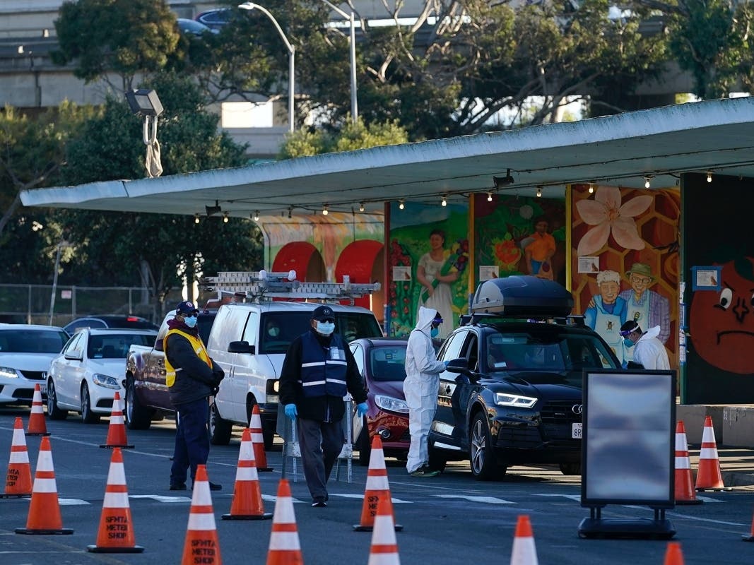 Healthcare workers give COVID-19 tests at the CityTestSF at Alemany Farmer's Market location during the coronavirus pandemic in San Francisco, Tuesday, Dec. 22, 2020. 