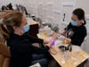 Sara Nguyen, right, sits behind a plexiglass shield as she gives a manicure. Gov Newsom lifted stay-at-home orders across the state Monday allowing restaurants and churches to resume outdoor operations and hair and nail salons to reopen in many areas. 