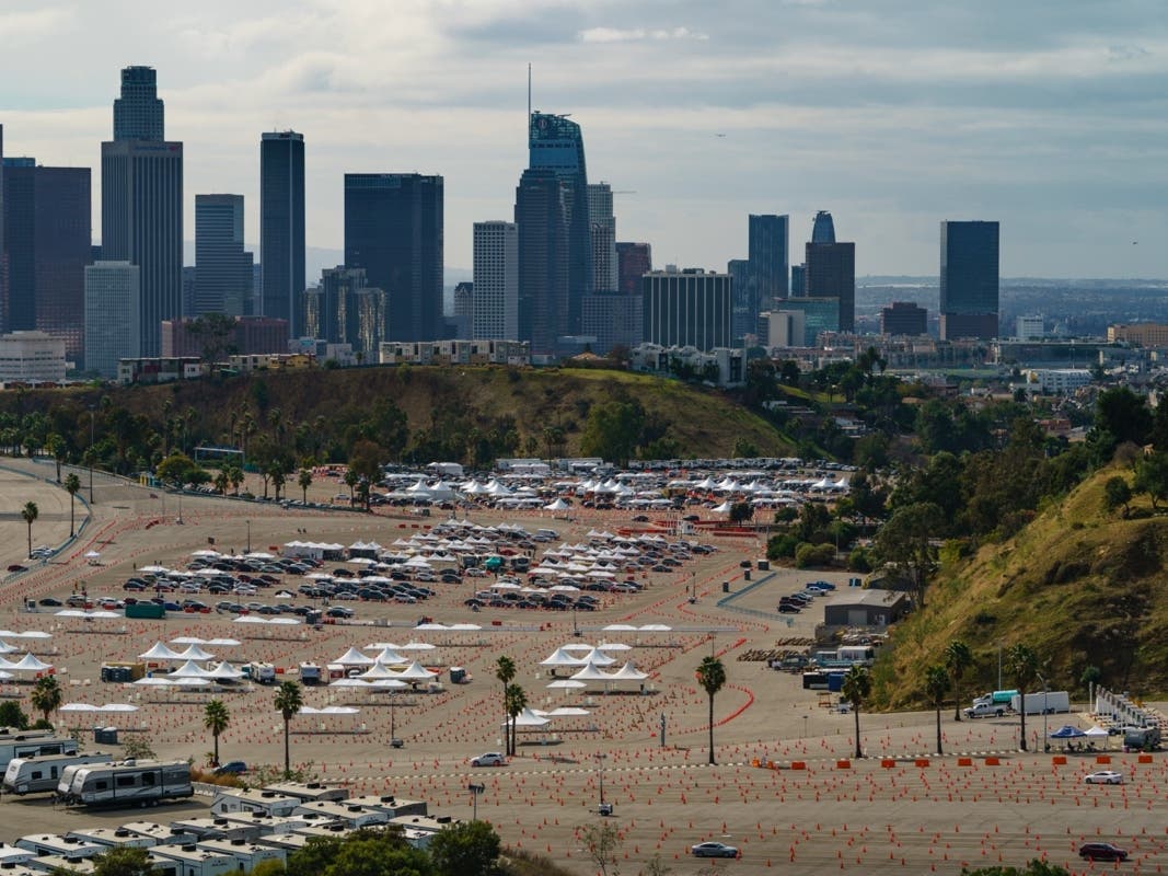  In this Jan. 27, 2021 file photo drivers wait in line at a mega COVID-19 vaccination site set up in the parking lot of Dodger Stadium in Los Angeles. 