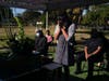 Lilah Matsumura, 11, prays for for her great-grandfather, Giichi Matsumura, during a memorial service at Woodlawn Cemetery in Santa Monica, Calif., Monday, Dec. 21, 2020. 