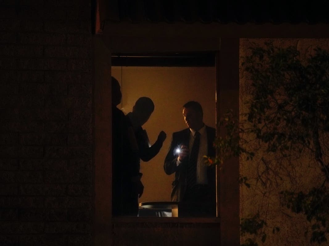 Investigators survey the scene at an office building after a shooting in Orange, Calif., Wednesday, March 31, 2021. 