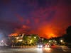 Smoke rises from a brush fire is seen behind homes in the Pacific Palisades area of Los Angeles Saturday, May 15, 2021. 
