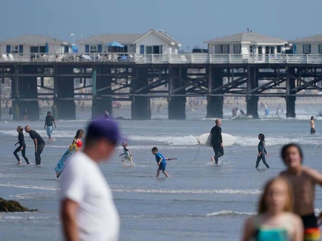 People play at the beach ahead of Memorial Day weekend Friday, May 28, 2021, in San Diego.