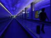 A traveler walks through the passenger tunnel at the new West Gates at Tom Bradley International Terminal at Los Angeles International Airport Monday, May 24, 2021, in Los Angeles.