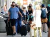 People arrive and depart from the airport ahead of Memorial Day weekend Friday, May 28, 2021, in San Diego. 