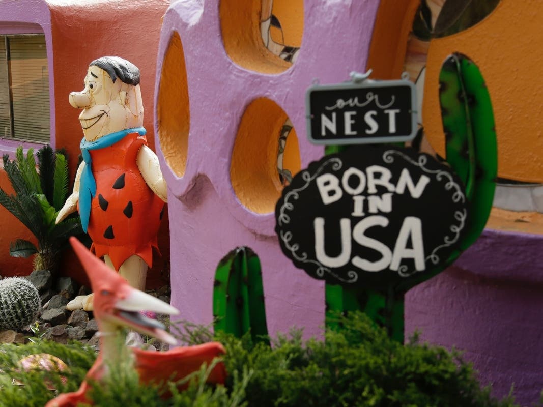 In this Thursday, April 11, 2019, file photo, a statue of Fred Flintstone stands near the front entryway of the Flintstone House in Hillsborough, Calif. 