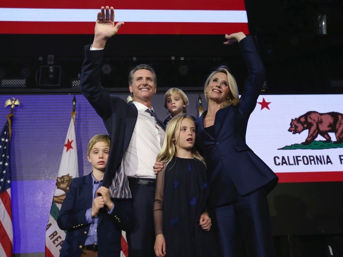 In this Nov. 6, 2018, file photo, then Lt. Gavin Newsom, a Democrat, holds his son, Dutch, 2, as he waves to the crowd at an election night party in Los Angeles after being elected California's 40th. Newsom was accompanied by his wife, Jennifer Siebel Ne