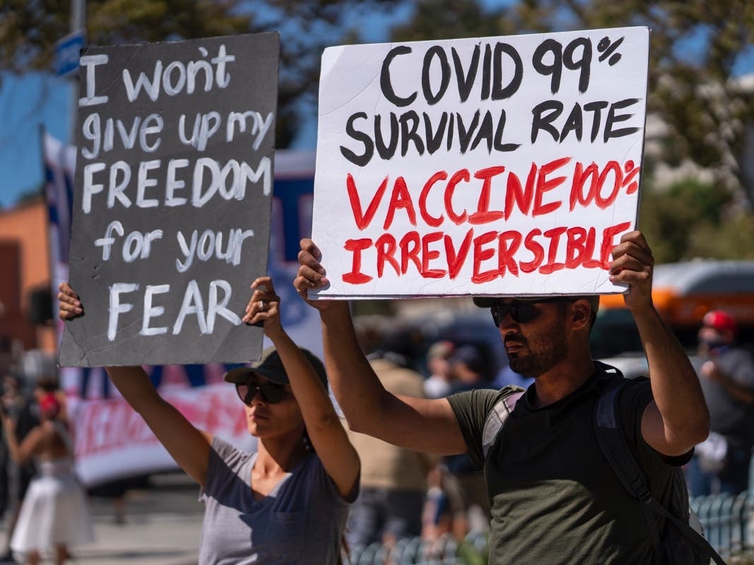 Protesters opposing COVID-19 vaccine mandates hold a rally in front of City Hall in downtown Los Angeles Saturday, Sept. 18, 2021. 