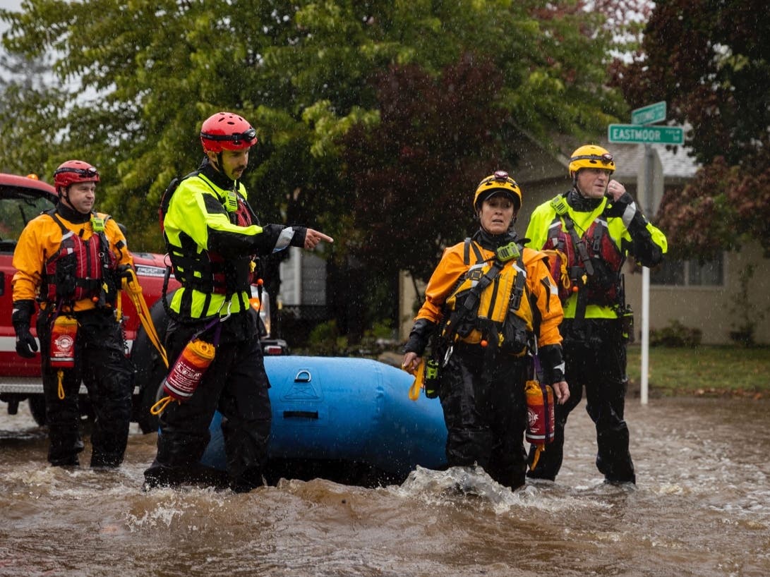 Santa Rosa firefighters check for residents trapped by floodwaters on Neotomas Avenue in Santa Rosa on Sunday.