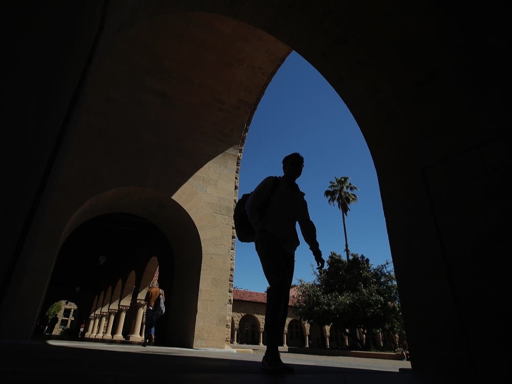 In this April 9, 2019, file photo, pedestrians walk on the campus at Stanford University in Stanford, Calif.