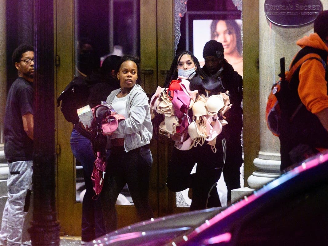 In this May 30, 2020, file photo, women carry merchandise from a Union Square Victoria's Secret store in San Francisco. 