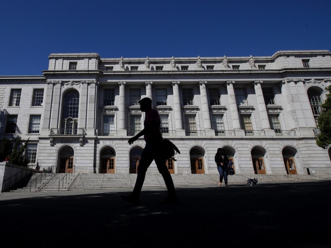 People walk in front of Wheeler Hall on the University of California campus in Berkeley, Calif.