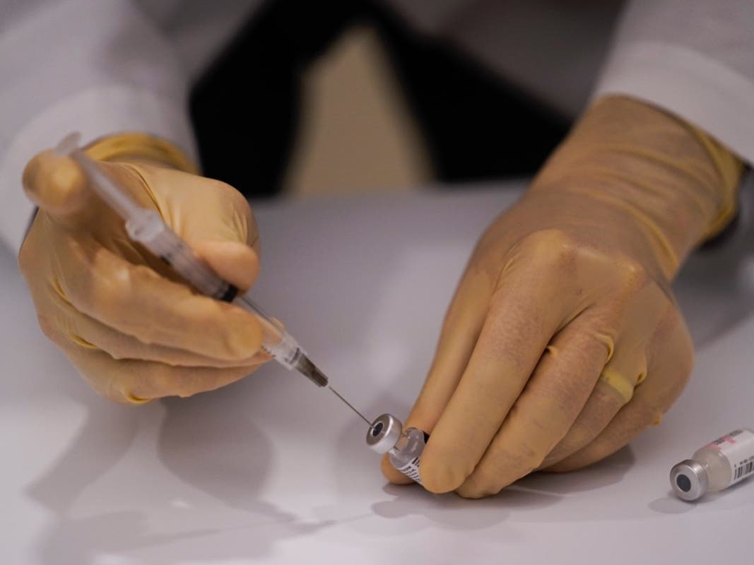 David Cheng, director of inpatient pharmacy, prepares the Pfizer-BioNTech COVID-19 vaccine at Kaiser Permanente Los Angeles Medical Center in Los Angeles. 