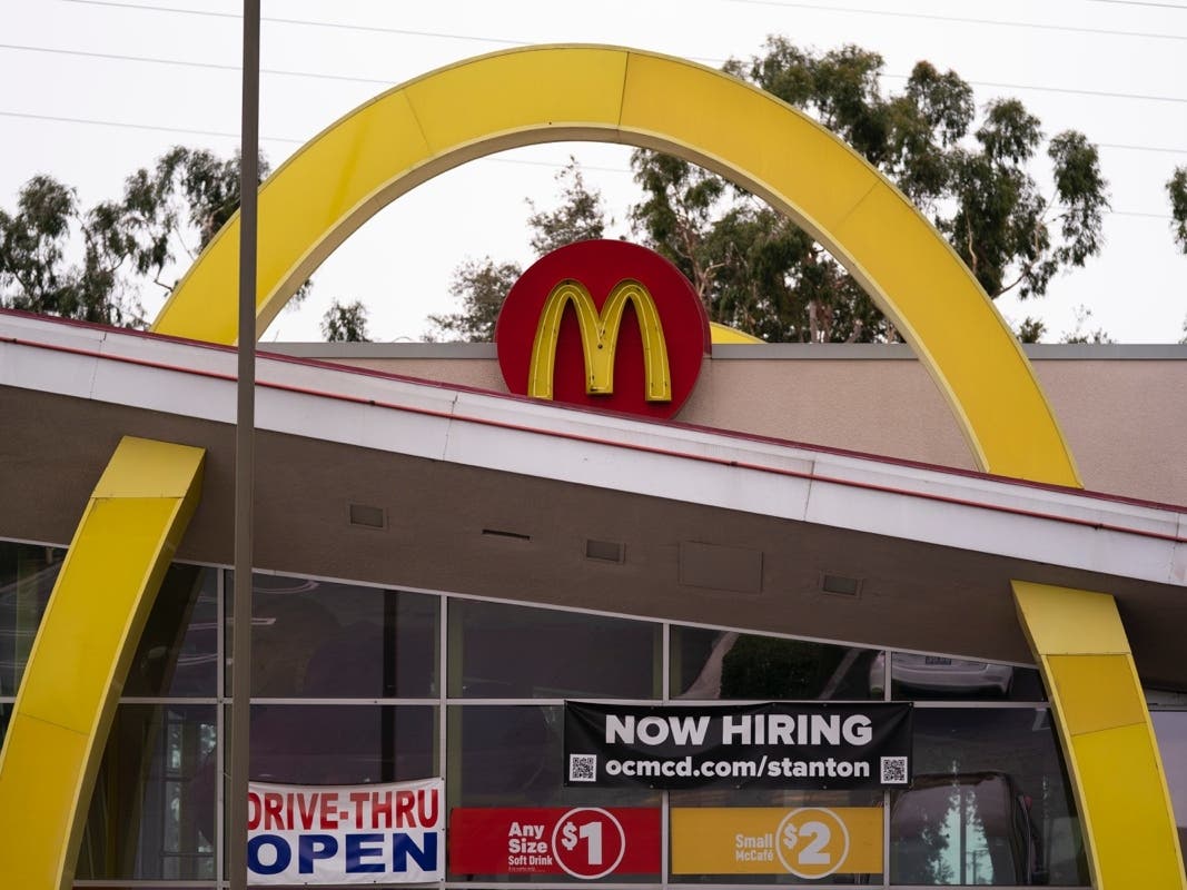 A hiring banner hangs outside a McDonald's fast-food restaurant in Stanton, Calif.