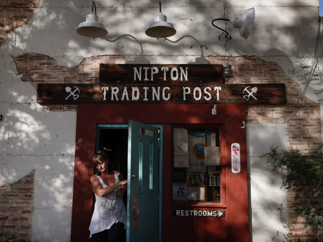  In this Aug. 3, 2017, file photo, a woman leaves the Nipton Trading Post in Nipton, Calif.